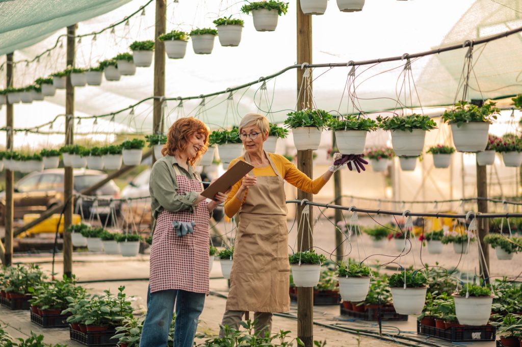 Botanists taking notes on progress of their hanging greenhouse garden.