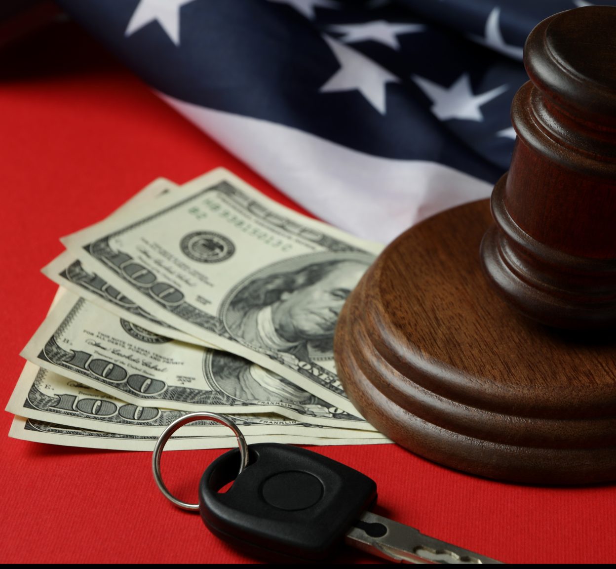 Judge gavel with cash and car keys representing California escheatment law that requires companies to turn over unclaimed property to the state