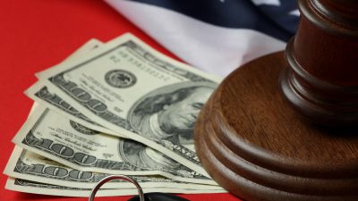 Judge gavel with cash and car keys representing California escheatment law that requires companies to turn over unclaimed property to the state